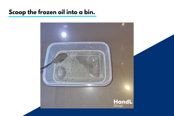 A silver spoon scooping frozen cooking oil out of a tub into a bin