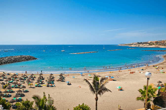 golden sand beach with blue sea in tenerife