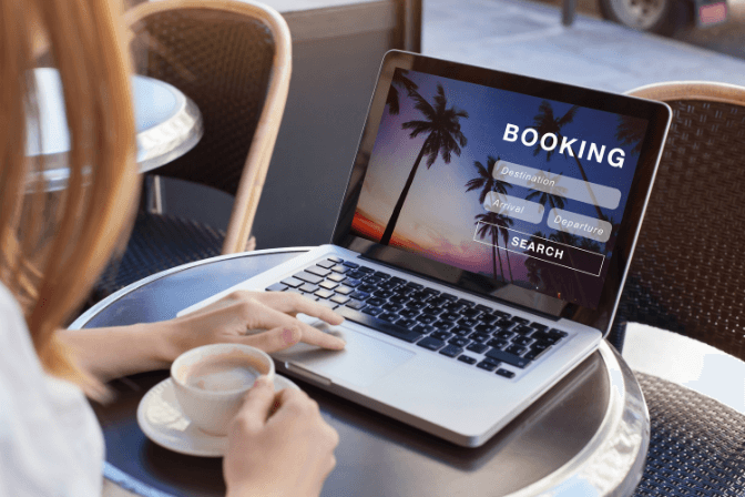 booking a holiday on a laptop on a table.