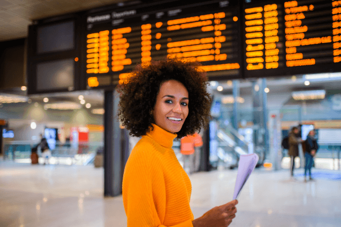 woman waiting in airport with ticket