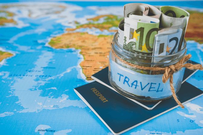 pot of travel money on a world map