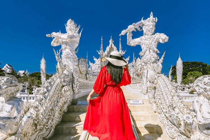 woman in red dress in temple in thailand