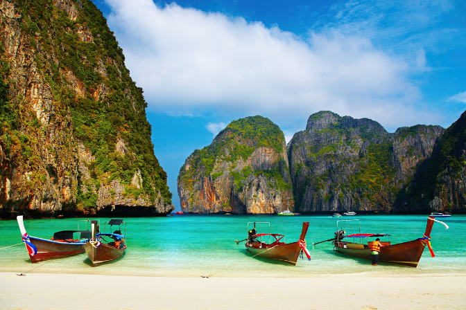 beach in thailand with boats on