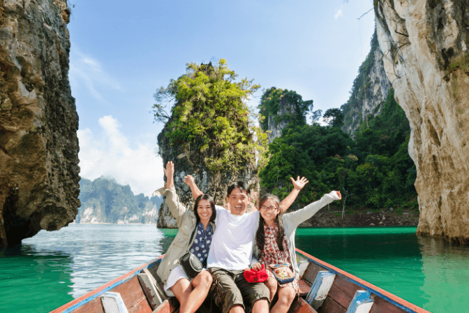 thai family on a boat in koh phi phi