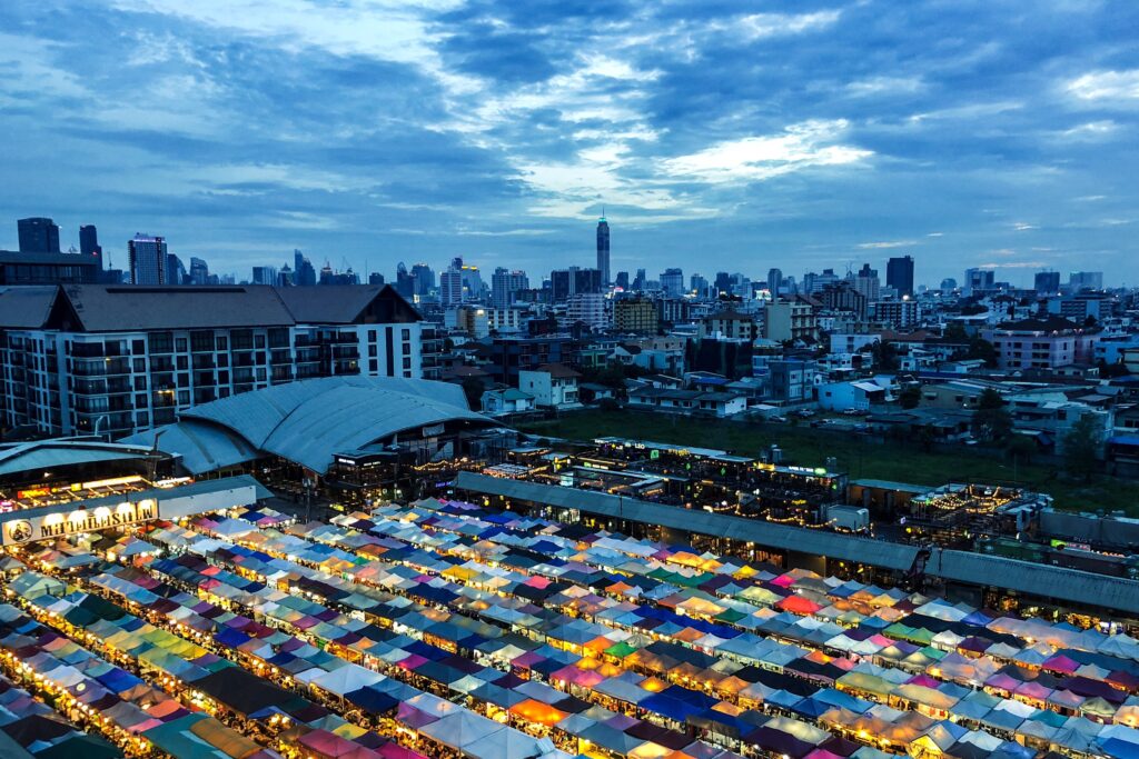 beautiful-shot-market-tents-near-buildings-blue-cloudy-sky